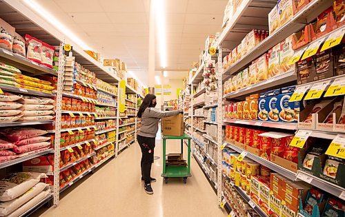 MIKE SUDOMA / WINNIPEG FREE PRESS 
Clerk, Jaaziel Manguerra, stocks the shelves of an aisle in brand new Freshco store located on Sargeant and Sherbrooke. The store is open for business Friday morning
March 21, 2021