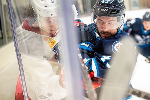 MIKE SUDOMA / WINNIPEG FREE PRESS 
Moose Left Wing, Skyler McKenzie, takes Laval Defence, Cale Feury into the boards as the Manitoba Moose face off against the Laval Rocket Thursday evening at the Bell MTS Iceplex 
March 21, 2021