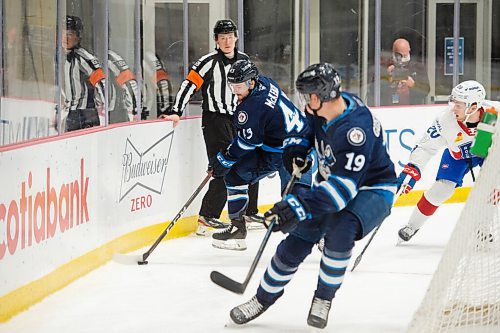 MIKE SUDOMA / WINNIPEG FREE PRESS 
Moose Centre, Left Wing, Skyler McKenzie passes the puck down the boards to Centre, David Gustafsson as the Manitoba Moose face off against the Laval Rocket Thursday evening at the Bell MTS Iceplex 
March 21, 2021