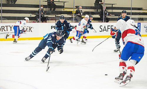 MIKE SUDOMA / WINNIPEG FREE PRESS 
Moose Centre, Cole Perfetti, goes after Laval Defence, Josh Brook as the Manitoba Moose face off against the Laval Rocket Thursday evening at the Bell MTS Iceplex 
March 21, 2021