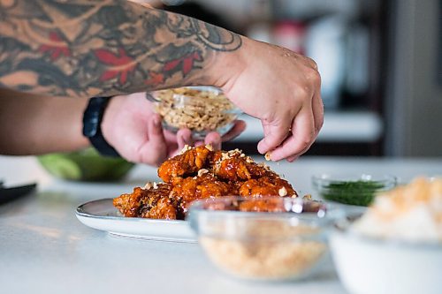 MIKAELA MACKENZIE / WINNIPEG FREE PRESS

Chef Mark Merano plates Korean fried chicken at home in Winnipeg on Monday, March 29, 2021.  For Eva Wasney story.

Winnipeg Free Press 2021