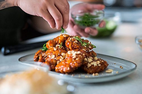 MIKAELA MACKENZIE / WINNIPEG FREE PRESS

Chef Mark Merano plates Korean fried chicken at home in Winnipeg on Monday, March 29, 2021.  For Eva Wasney story.

Winnipeg Free Press 2021