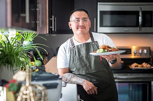 MIKAELA MACKENZIE / WINNIPEG FREE PRESS

Chef Mark Merano poses with his Korean fried chicken at home in Winnipeg on Monday, March 29, 2021.  For Eva Wasney story.

Winnipeg Free Press 2021