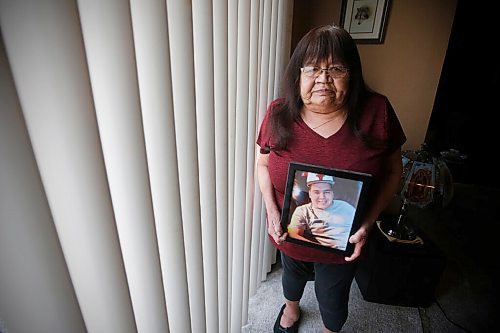 JOHN WOODS / WINNIPEG FREE PRESS
Gloria Lebold, the grandmother of Cody Severight, who was killed in a hit-and-run in 2017 by off duty police officer Justin Holz who was driving and fled the scene, looks at a photo of Cody in her home in Winnipeg Tuesday, March 30, 2021. Lebold didnt know the former police officer who killed her grandson in a hit and run had been granted parole last year, and that he admitted to being drunk

Reporter: Rollason