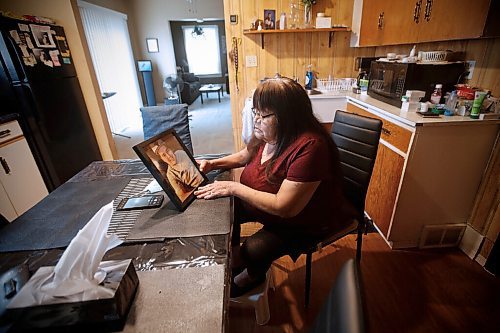 JOHN WOODS / WINNIPEG FREE PRESS
Gloria Lebold, the grandmother of Cody Severight, who was killed in a hit-and-run in 2017 by off duty police officer Justin Holz who was driving and fled the scene, looks at a photo of Cody in her home in Winnipeg Tuesday, March 30, 2021. Lebold didnt know the former police officer who killed her grandson in a hit and run had been granted parole last year, and that he admitted to being drunk

Reporter: Rollason