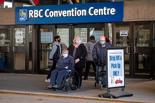 Daniel Crump / Winnipeg Free Press. People wait to be picked-up outside the RBC Convention Centre downtown after receiving their COVID-19 vaccinations Wednesday afternoon. March 31, 2021.