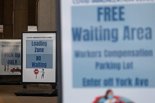 Daniel Crump / Winnipeg Free Press. Signs indicate the drop-pff and pick-up area for people getting their COVID-19 vaccines at the RBC Convention Centre in downtown Winnipeg. March 31, 2021.