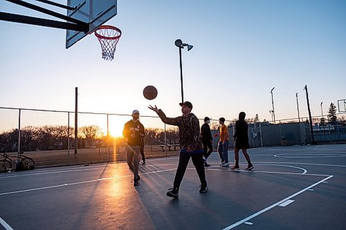 Daniel Crump / Winnipeg Free Press. A group of friends play basketball at the Corydon Community Centre in Crescentwood on Wednesday evening. March 31, 2021.