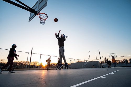 Daniel Crump / Winnipeg Free Press. Benji Munro take a shot as he plays basketball with a group of friends at the Corydon Community Centre in Crescentwood on Wednesday evening. March 31, 2021.