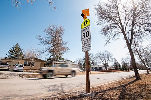 MIKE SUDOMA / WINNIPEG FREE PRESS 
A truck drives by a school zone speed limit sign adorned with a new blinking amber light on Bedson St Thursday morning
April 1, 2021