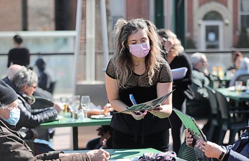 RUTH BONNEVILLE / WINNIPEG FREE PRESS 

Local -  Weather Standup 

Magda Buratchuk, takes food orders from customers on the patio as they take advantage of the sunshine and warming temperatures at Saffrons on Corydon on Thursday.  
 

April 01, 2021