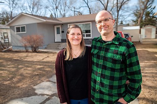 Daniel Crump / Winnipeg Free Press.  Emergency room nurses Cameron and Lindsay Green in front of their St. Vital home. Last April, not long after the beginning of the pandemic, anonymous neighbours cleared all of the snow from the Greens driveway after a big spring storm. April 2, 2021.