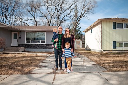 Daniel Crump / Winnipeg Free Press.  Emergency room nurses Cameron and Lindsay Green with their two children four-year-old Harrison and one-year-old Tulla in front of their St. Vital home. Last April, not long after the beginning of the pandemic, anonymous neighbours cleared all of the snow from the Greens driveway after a big spring storm. April 2, 2021.