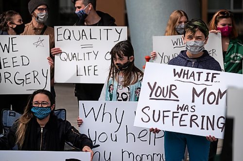 Daniel Crump / Winnipeg Free Press. People hold signs in front of the HSC Womens Hospital during a rally to draw attention to cancelled surgeries and other issues that have resulted in women not getting health care they need during the pandemic. April 3, 2021.