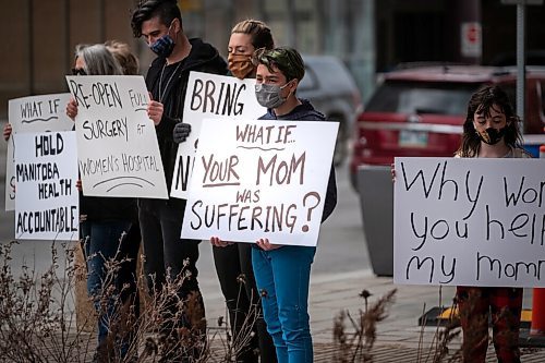 Daniel Crump / Winnipeg Free Press. People hold signs in front of the HSC Womens Hospital during a rally to draw attention to cancelled surgeries and other issues that have resulted in women not getting health care they need during the pandemic. April 3, 2021.