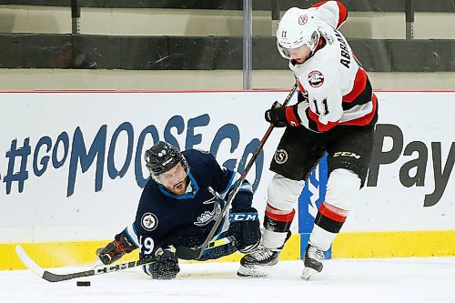 JOHN WOODS / WINNIPEG FREE PRESS
Manitoba Moose Haralds Egle (49) clears the puck after getting checked by Belleville Senators Vitaly Abramov (11) during first period AHL action in Winnipeg on Wednesday, April 7, 2021.

Reporter: ?