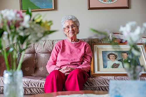 MIKAELA MACKENZIE / WINNIPEG FREE PRESS

Ruth Schroeder poses for a portrait with a wedding photo and anniversary flowers at her home in Morris on Thursday, April 8, 2021. John and Ruth Schroeder have been married for 76 years. For Jen Zoratti story.

Winnipeg Free Press 2021