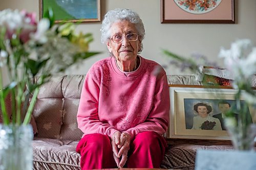 MIKAELA MACKENZIE / WINNIPEG FREE PRESS

Ruth Schroeder poses for a portrait with a wedding photo and anniversary flowers at her home in Morris on Thursday, April 8, 2021. John and Ruth Schroeder have been married for 76 years. For Jen Zoratti story.

Winnipeg Free Press 2021