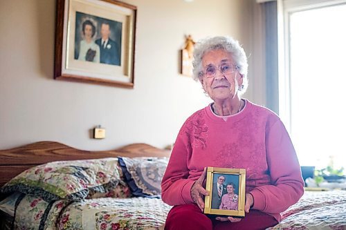 MIKAELA MACKENZIE / WINNIPEG FREE PRESS

Ruth Schroeder poses for a portrait with a wedding photo behind her and an anniversary photo (she believes its their 50th) at her home in Morris on Thursday, April 8, 2021. John and Ruth Schroeder have been married for 76 years. For Jen Zoratti story.

Winnipeg Free Press 2021