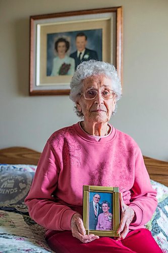 MIKAELA MACKENZIE / WINNIPEG FREE PRESS

Ruth Schroeder poses for a portrait with a wedding photo behind her and an anniversary photo (she believes its their 50th) at her home in Morris on Thursday, April 8, 2021. John and Ruth Schroeder have been married for 76 years. For Jen Zoratti story.

Winnipeg Free Press 2021