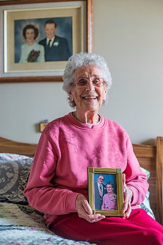 MIKAELA MACKENZIE / WINNIPEG FREE PRESS

Ruth Schroeder poses for a portrait with a wedding photo behind her and an anniversary photo (she believes its their 50th) at her home in Morris on Thursday, April 8, 2021. John and Ruth Schroeder have been married for 76 years. For Jen Zoratti story.

Winnipeg Free Press 2021