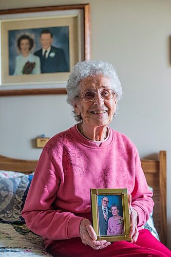 MIKAELA MACKENZIE / WINNIPEG FREE PRESS

Ruth Schroeder poses for a portrait with a wedding photo behind her and an anniversary photo (she believes its their 50th) at her home in Morris on Thursday, April 8, 2021. John and Ruth Schroeder have been married for 76 years. For Jen Zoratti story.

Winnipeg Free Press 2021