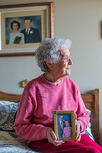 MIKAELA MACKENZIE / WINNIPEG FREE PRESS

Ruth Schroeder poses for a portrait with a wedding photo behind her and an anniversary photo (she believes its their 50th) at her home in Morris on Thursday, April 8, 2021. John and Ruth Schroeder have been married for 76 years. For Jen Zoratti story.

Winnipeg Free Press 2021