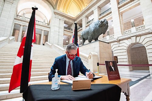 MIKE SUDOMA / WINNIPEG FREE PRESS  
Premier of Manitoba, Brian Pallister, signs a book of condolencesto honour the late Prince Philip, Duke of Edinburgh at the Manitoba Legislative Building Friday morning
April 9, 2021