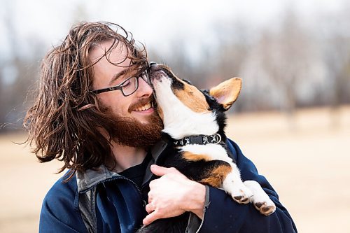 MIKE SUDOMA / WINNIPEG FREE PRESS  
Trevor Hale and his 5 month old pup, Luna, share a moment after going for a run at the off leash Dog Park on Grant and Moray Friday afternoon
April 9, 2021