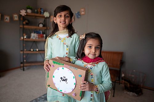 Daniel Crump / Winnipeg Free Press. (L to R) Ayza Waleed, 7, and Sarah Waleed, 4, hold a ramadan craft they made in preparation for the muslim holiday. April 10, 2021.