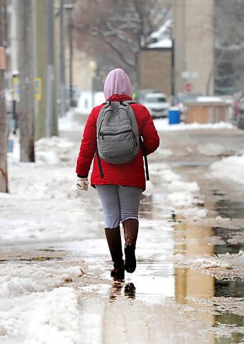 RUTH BONNEVILLE / WINNIPEG FREE PRESS 

LOCAL - Messy, wet streets 

A person walks around puddles near Broadway Ave. on Wednesday after snowstorm hit the city earlier in the week. 

April 14,  2021