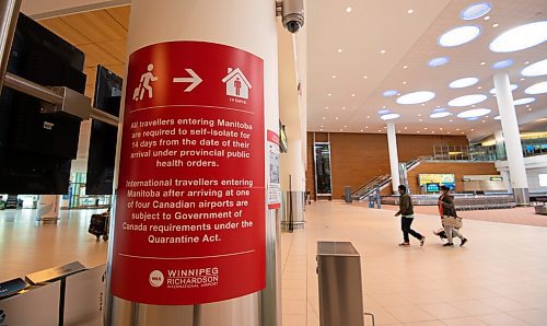 MIKE SUDOMA / WINNIPEG FREE PRESS
Signage instructing travellers to self isolate after entering Manitoba can be found on pillars in the arrival terminal of the Winnipeg James Armstrong Richardson International Airport Friday.
April 16, 2021