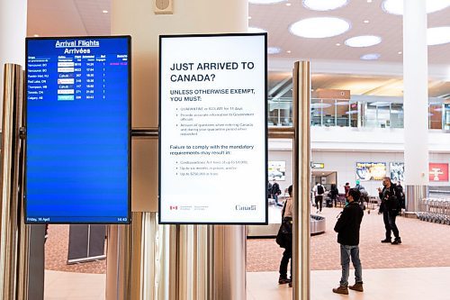 MIKE SUDOMA / WINNIPEG FREE PRESS  
Electronic signage indicating quarantine/isolation practices for travellers entering Manitoba hang on a pillar as travellers grab their luggage at Winnipeg James Armstong Richardson International Airport Friday afternoon.
April 9, 2021