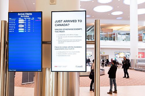 MIKE SUDOMA / WINNIPEG FREE PRESS  
Electronic signage indicating quarantine/isolation practices for travellers entering Manitoba hang on a pillar as travellers grab their luggage at Winnipeg James Armstong Richardson International Airport Friday afternoon.
April 16, 2021