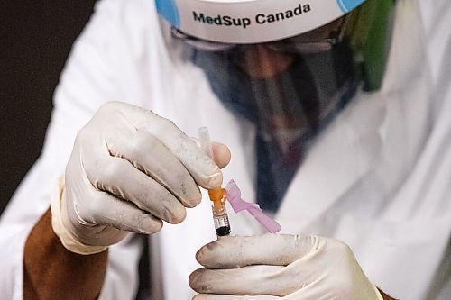 Daniel Crump / Winnipeg Free Press. Manitoba Metis Federation President David Chartrand gets a shot of the AstraZeneca COVID vaccine. Pharmacist Ayobola Ayobole-Obi administered the vaccine Saturday morning at the MEDOCare pharmacy located in the MMF building on Henry avenue in downtown Winnipeg. April 17, 2021.