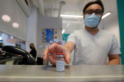 JOHN WOODS / WINNIPEG FREE PRESS
Ryan Chan, executive director of Exchange District Pharmacy, is photographed with a vial of AstraZeneca COVID-19 vaccine at his pharmacy in Winnipeg Tuesday, April 20, 2021. 

Reporter: Rollason