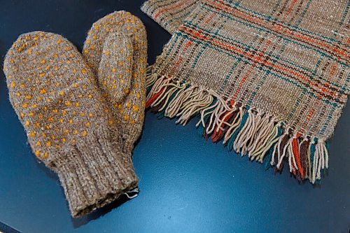 MIKE DEAL / WINNIPEG FREE PRESS
Curator Andrea Reichert of the Manitoba Crafts Museum and Library shows off artifacts held in storage that have a connection to the founding of this province.
Bison wool scarf and mittens made by Kitty Churchill in 1942. The coloured wool is sheep's wool, while the brown wool is from bison.
See Brenda Suderman story
210421 - Wednesday, April 21, 2021.
