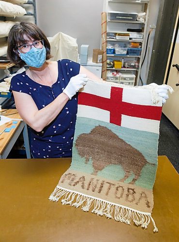 MIKE DEAL / WINNIPEG FREE PRESS
Curator Andrea Reichert of the Manitoba Crafts Museum and Library shows off artifacts held in storage that have a connection to the founding of this province.
A wall hanging tapestry made by Kitty Churchill where the bison and the word 'Manitoba' are made from bison wool.
See Brenda Suderman story
210421 - Wednesday, April 21, 2021.