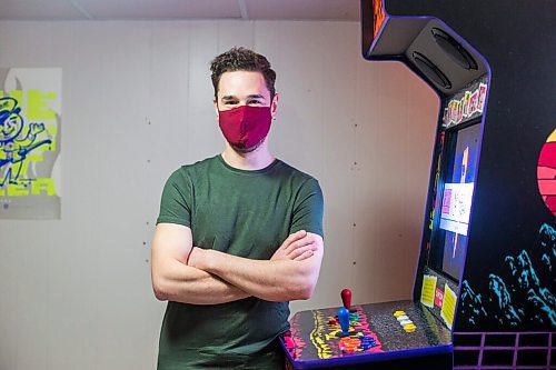 MIKAELA MACKENZIE / WINNIPEG FREE PRESS

Adam Delbridge, who built an vintage arcade video game cabinet and also repairs and modifies retro gaming consoles, poses for a portrait in his basement in Winnipeg on Wednesday, April 21, 2021. For Declan story.
Winnipeg Free Press 2020.