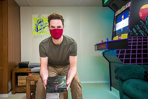 MIKAELA MACKENZIE / WINNIPEG FREE PRESS

Adam Delbridge, who built an vintage arcade video game cabinet and also repairs and modifies retro gaming consoles, poses for a portrait in his basement in Winnipeg on Wednesday, April 21, 2021. For Declan story.
Winnipeg Free Press 2020.