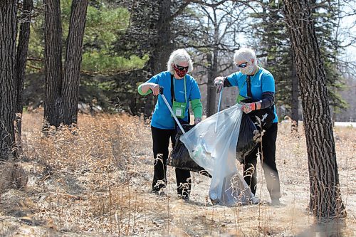 RUTH BONNEVILLE / WINNIPEG FREE PRESS 

Standup - Earth Day cleanup 

Ambassadors with the Assiniboine Park Zoo, volunteers, Sharon Williams (red mask) and Katherine Cullihall, clean up garbage next to the zoo fence line and inside the Assiniboine Park on Earth Day Thursday.  

April 22,  2021