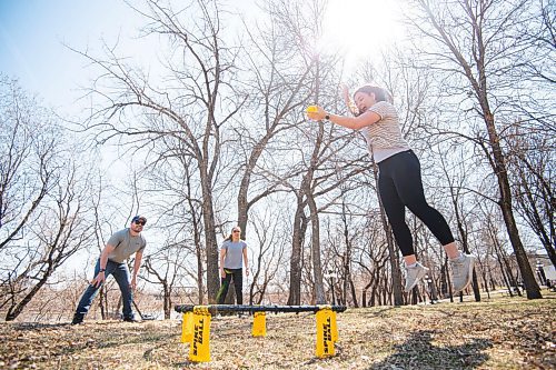 MIKE SUDOMA / WINNIPEG FREE PRESS  
Courtney Engel jumps to pass the ball to co-workers, Josh Murray and Carriera Lamoureux as they spend their offices Wellness Hour playing a game called Spike Ball in Stephen Juba Park Friday afternoon
April 22, 2021