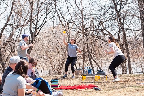 MIKE SUDOMA / WINNIPEG FREE PRESS  
Carriera Lamoureux passes the ball to co-workers, Josh Murray and Carriera Lamoureux, while the rest of their co-workers watch as they spend their offices Wellness Hour playing a game called Spike Ball in Stephen Juba Park Friday afternoon
April 22, 2021