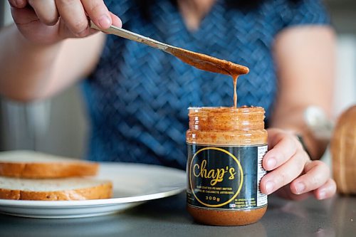 Daniel Crump / Winnipeg Free Press. Sarah Belesario scoops some peanut butter out of a jar. The peanut butter is made using her grandmothers old recipe. April 22, 2021.