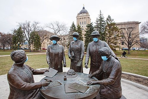 MIKE DEAL / WINNIPEG FREE PRESS
As the province heads into another round of more stringent restrictions someone has put PPE masks on the monument to the Famous Five located on the ground of the Manitoba Legislative building Monday morning. (from left) Henrietta Muir Edwards, Emily Murphy, Irene Parlby, Louise McKinney and Nellie McClung.
210426 - Monday, April 26, 2021.