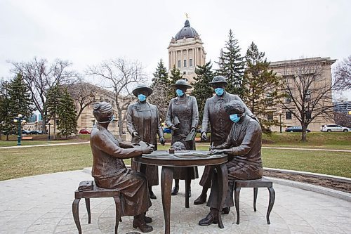 MIKE DEAL / WINNIPEG FREE PRESS
As the province heads into another round of more stringent restrictions someone has put PPE masks on the monument to the Famous Five located on the ground of the Manitoba Legislative building Monday morning. (from left) Henrietta Muir Edwards, Emily Murphy, Irene Parlby, Louise McKinney and Nellie McClung.
210426 - Monday, April 26, 2021.