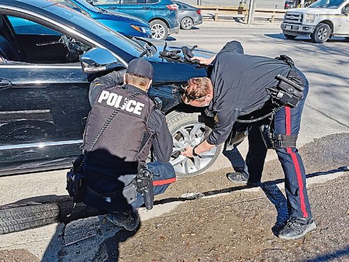Canstar Community News Herb Bjarnason sent us this photo of two Winnipeg  Police Service officers who kindly changed a flat tire for him last month.