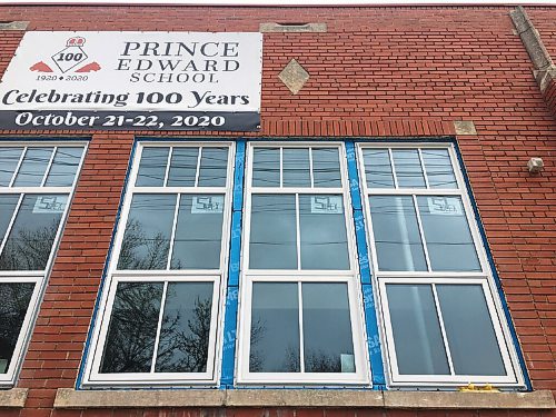 Canstar Community News Blue and spray foam insulation can be seen around Prince Edward Schools new energy-efficient, custom-made, historic looking window frames. 
