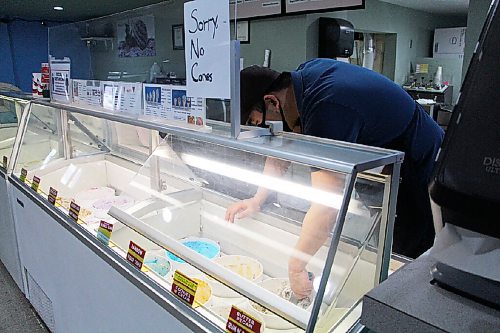 Canstar Community News Heuitai Lee scoops hard ice cream at E's Ice Cream on April 19. The shop currently isn't selling cones. (GABRIELLE PICHÉ/CANSTAR COMMUNITY NEWS/HEADLINER)