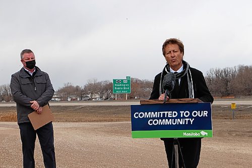 Canstar Community News Infrastructure Minister Ron Schuler, right, talks about the government's investment in a new road in the RM of Headingley while the municipality's mayor, John Mauseth, stands by. (GABRIELLE PICHÉ/CANSTAR COMMUNITY NEWS/HEADLINER)